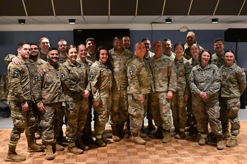 Military member gather for a group photo.