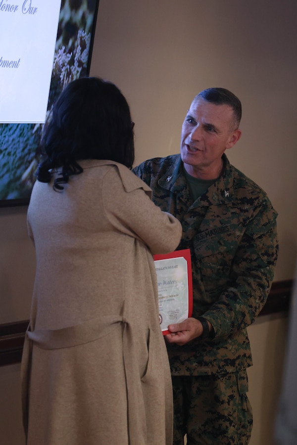 U.S. Marine Corps Col. Ralph J. Rizzo, Jr., commander, Marine Corps Installations East-Marine Corps Base (MCB) Camp Lejeune, congratulates a civilian employee at the annual Civilian Leadership Development luncheon at The Club at Paradise Point on Marine Corps Base Camp Lejeune, North Carolina, Nov. 14, 2024. The annual luncheon is a celebration of those employees who participated in the Civilian Leadership Development program, demonstrating their desire and commitment to outstanding leadership of both service members and civilians working throughout MCB Camp Lejeune. (U.S. Marine Corps photo by Cpl. Zeta Johnson)