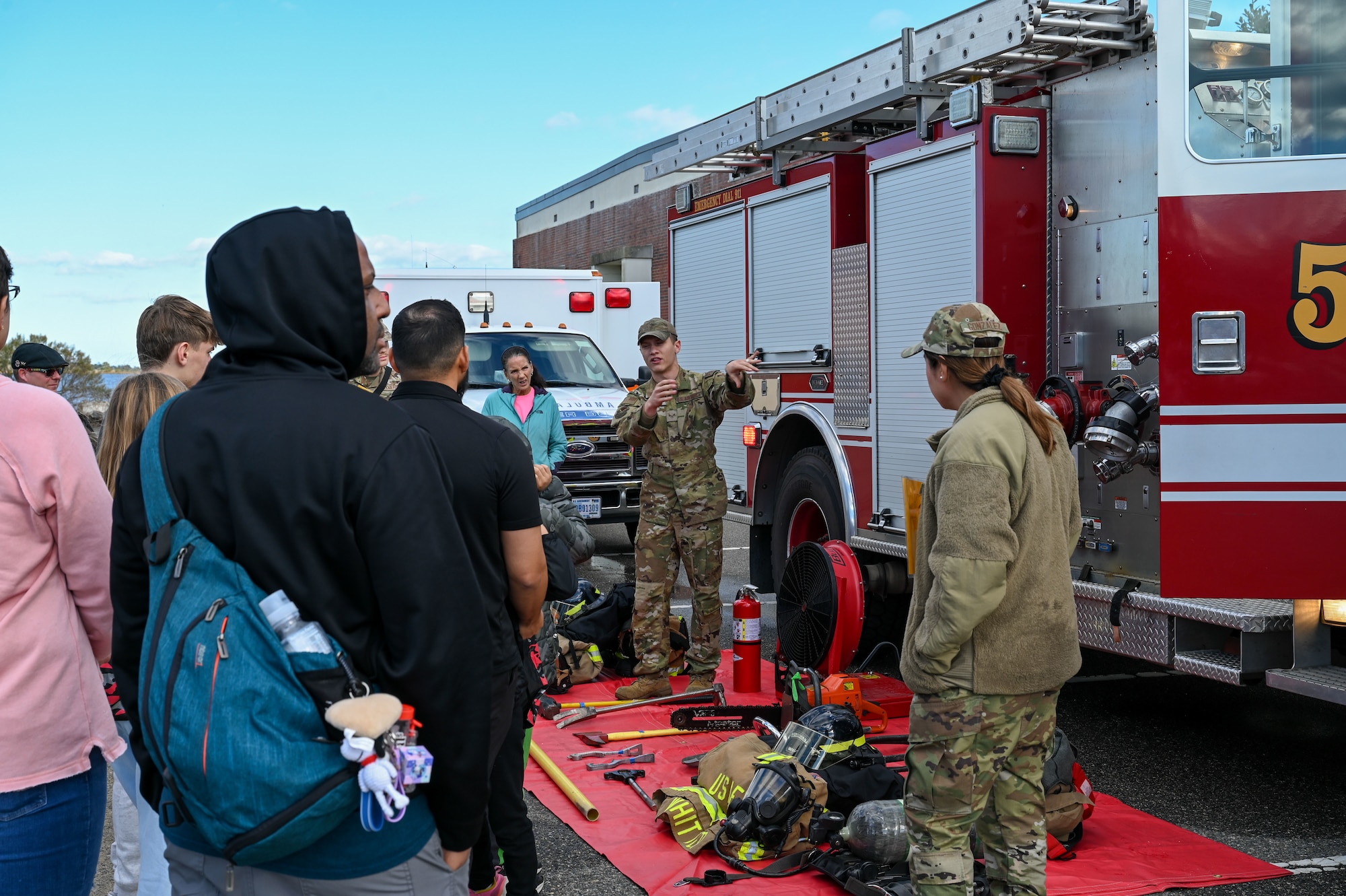 Airman briefs people about firetrucks. (U.S. Air Force photo by Senior Airman Abigayl Salyer)