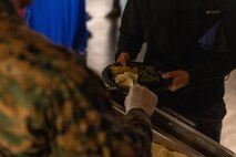 U.S. Marine Corps leaders with Headquarters and Service Battalion serve food to Marines at a friendsgiving event coordinated by the Depot Single Marine Program at Marine Corps Recruit Depot San Diego, California, Nov. 20, 2024.  Friendsgiving is part of Spiritual Fitness Month, The Depot celebrated Spiritual Fitness Month, a program implemented to bring inner strength from higher purpose, with a friendsgiving event. MCRDSD is the first Marine Corps base to implement the Spiritual Fitness Month program. (U.S. Marine Corps photo by Cpl. Alexander O. Devereux)