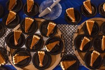Slices of pumpkin pie are presented on a table at a friendsgiving event coordinated by the Depot Single Marine Program at Marine Corps Recruit Depot San Diego, California, Nov. 20, 2024.  Friendsgiving is part of Spiritual Fitness Month, The Depot celebrated Spiritual Fitness Month, a program implemented to bring inner strength from higher purpose, with a friendsgiving event. MCRDSD is the first Marine Corps base to implement the Spiritual Fitness Month program. (U.S. Marine Corps photo by Cpl. Alexander O. Devereux)