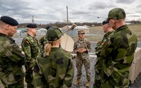 U.S. Army Lt. Col. Elsa Canales, support operations officer for the 369th Sustainment Brigade, New York National Guard, speaks with members of the Swedish military as she gives them a tour of the 42nd Infantry Division’s command post exercise operations at Fort Indiantown Gap, Pa., Nov. 21, 2024.  The New York National Guard and Sweden entered into an official partnership as part of the National Guard’s State Partnership Program in July, focusing on shared values and training to build relationships and capabilities for both military forces.