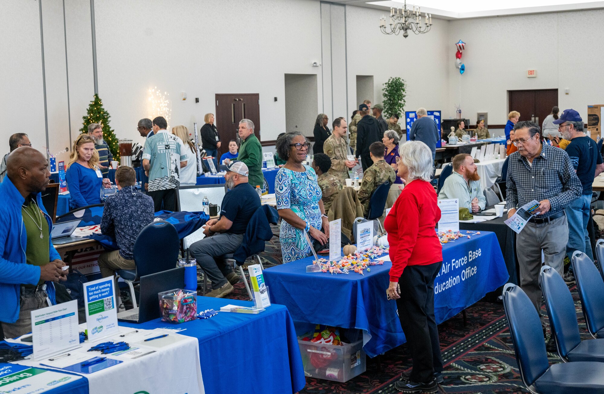 Retirees and dependents receive information about various services available to them during the 36th annual Retiree Appreciation Day event on Scott Air Force Base, Illinois, Nov. 23, 2024. At the end of the event, members of Team Scott performed a salute to veterans, one for each combat era, going back to WWII. (U.S. Air Force photo by Staff. Sgt. Stephanie Henry)