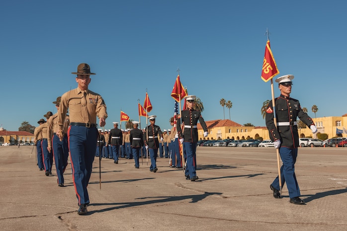 U.S. Marine Corps drill instructors with Alpha Company, 1st Recruit Training Battalion, march beside the guides in formation during a graduation ceremony at Marine Corps Recruit Depot San Diego, California, Nov. 22, 2024. This ceremony marked the end of a 13-week transformation that included training in drill, marksmanship, basic combat skills, and Marine Corps customs and traditions. (U.S. Marine Corps photo by Lance Cpl. Janell B. Alvarez)