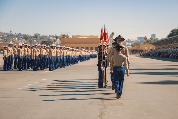 U.S. Marine Corps drill instructors with Alpha Company, 1st Recruit Training Battalion, march in formation prior to returning the guidon during a graduation ceremony at Marine Corps Recruit Depot San Diego, California, Nov. 22, 2024. This ceremony marked the end of a 13-week transformation that included training in drill, marksmanship, basic combat skills, and Marine Corps customs and traditions. (U.S. Marine Corps photo by Lance Cpl. Janell B. Alvarez)