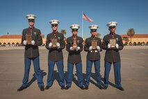 U.S. Marines with Alpha Company, 1st Recruit Training Battalion, pose for a photo after a graduation ceremony at Marine Corps Recruit Depot San Diego, California, Nov. 22, 2024. This ceremony marked the end of a 13-week transformation that included training in drill, marksmanship, basic combat skills, and Marine Corps customs and traditions. (U.S. Marine Corps photo by Lance Cpl. Janell B. Alvarez)