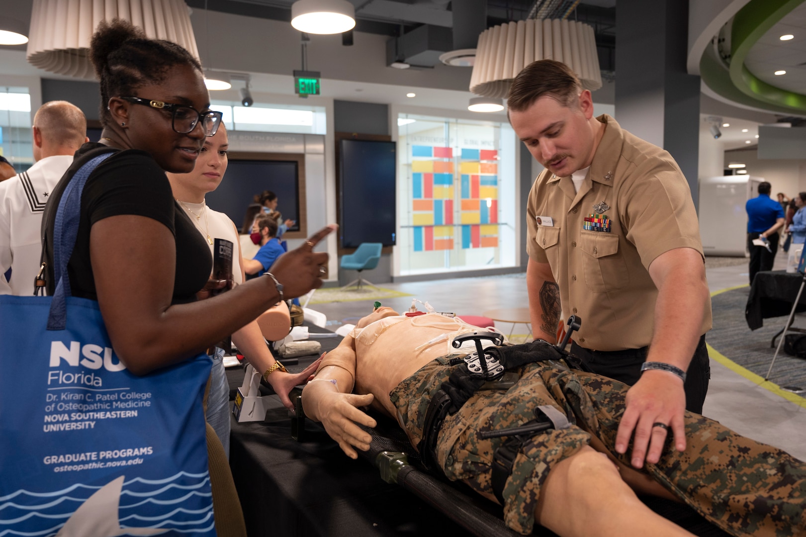 Hospital Corpsman Second Class C. Wallace demonstrates a medical simulation manikin during a recruiting event for health care students in Miami, FL on Sept. 26, 2024.