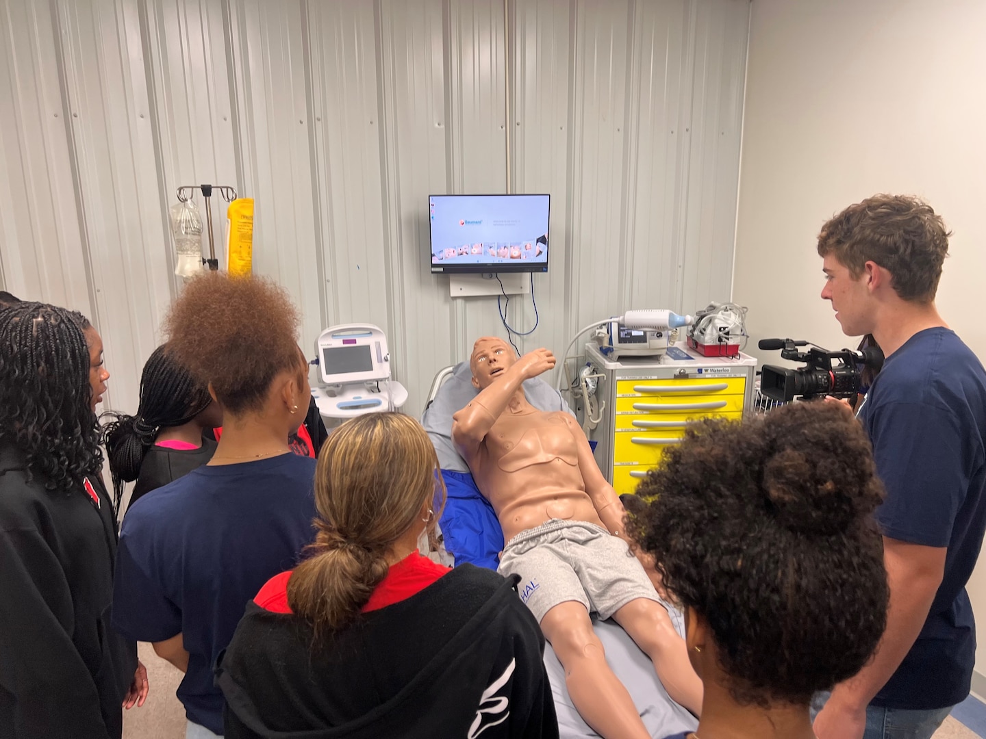 High school students witness the capabilities of a medical simulation manikin during a STEM Fair event at Naval Medical Center Camp Lejeune on Nov. 1, 2024. Students toured the NMCCL Healthcare Bioskills and Simulation Center as part of their visit to the medical center.