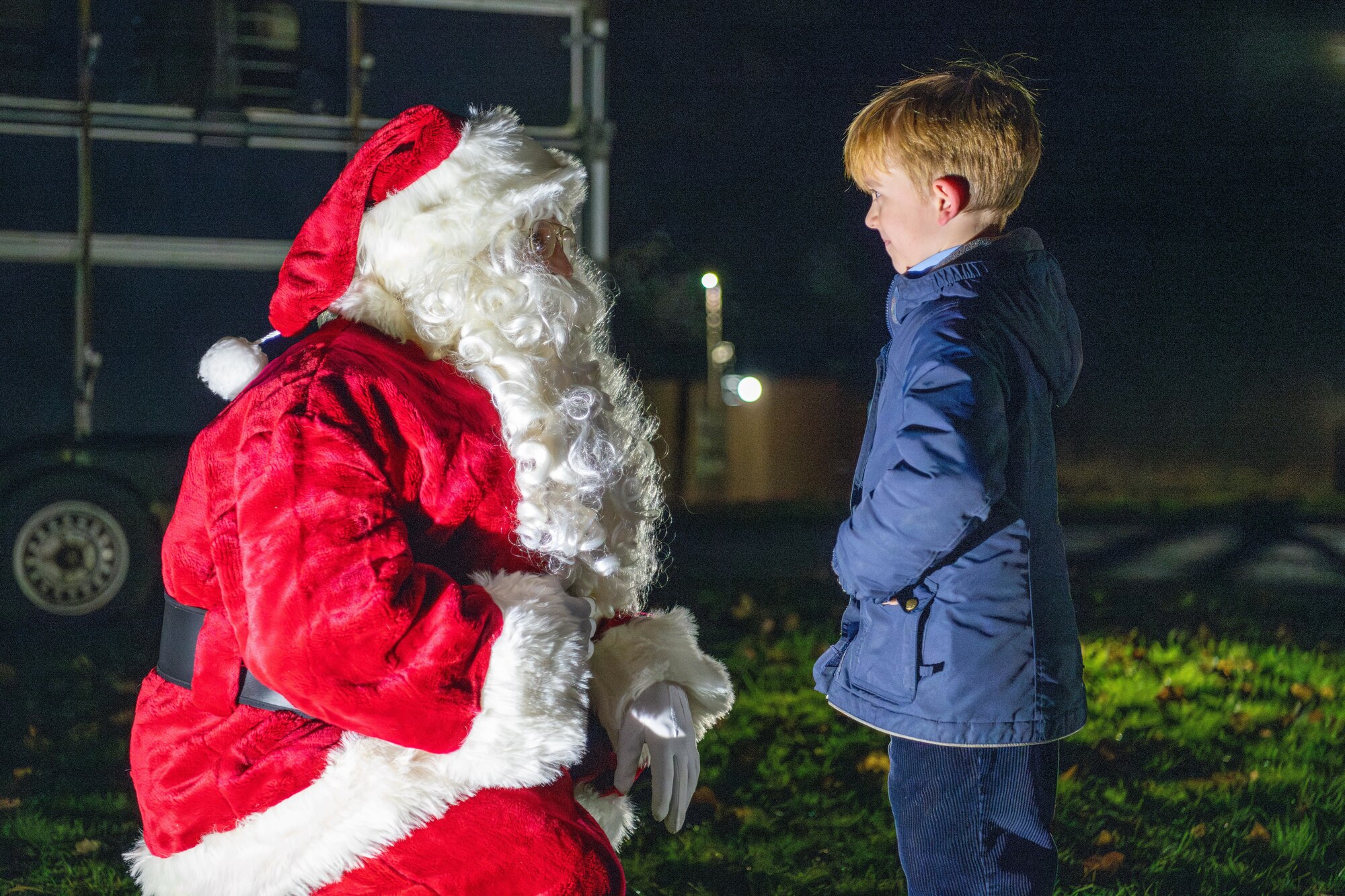 A child meets Santa Claus during a holiday market