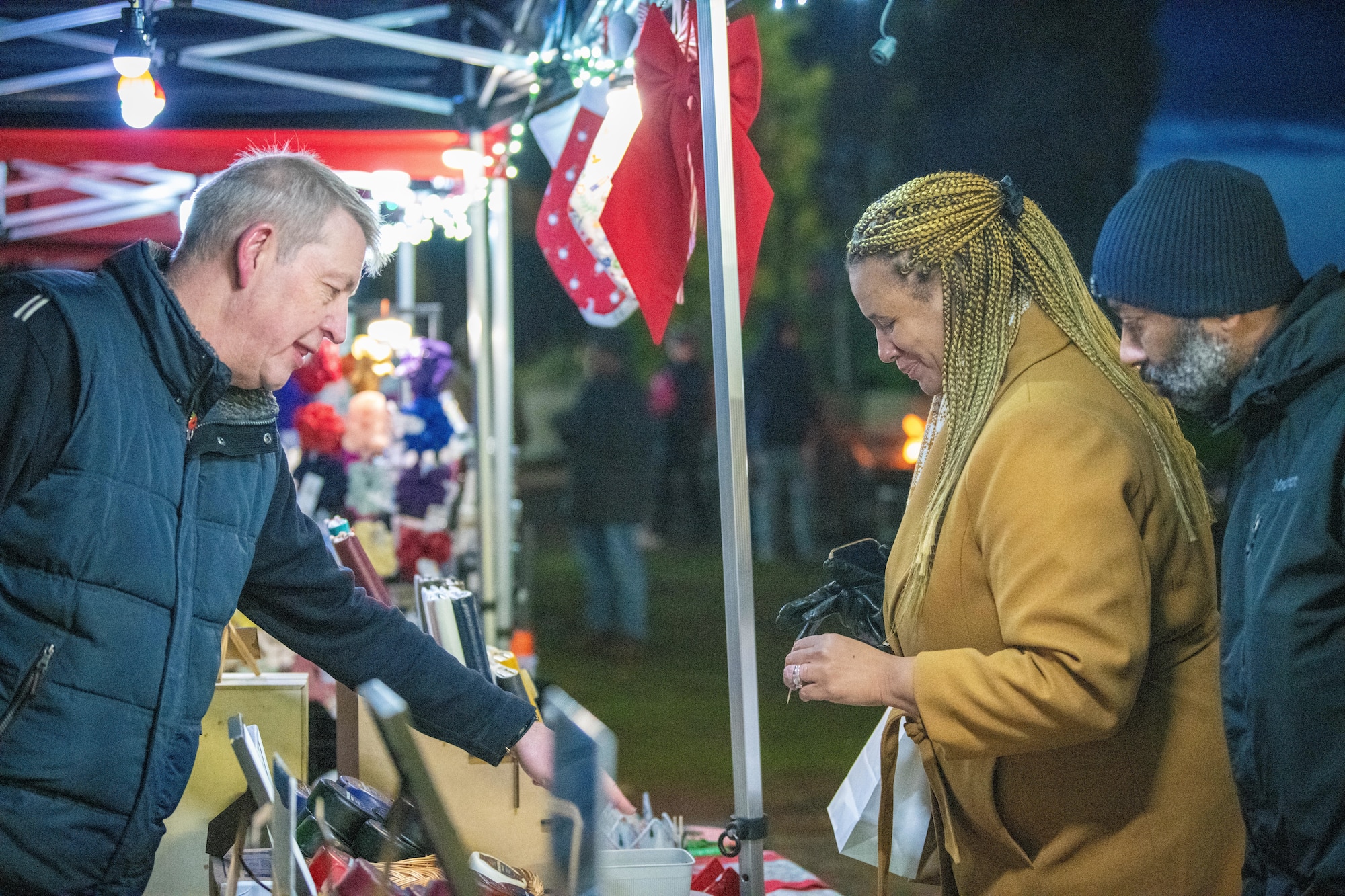 Shoppers browse products at a holiday market