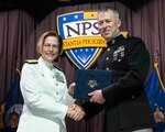 Vice Adm. Kelly Aeschbach, commander, Naval Information Forces (NAVIFOR), congratulates then U.S. Marine Corps Maj. Thomas Cecil during the NPS Spring Quarter graduation ceremony in King Hall, June 21. An award-winning graduate from NPS’ Modeling, Virtual Environments and Simulation (MOVES) program, Cecil is one of six nominees for the Best Paper Award at the world’s largest modeling, simulation and training conference, held in Orlando, Florida in early December 2024. (U.S. Navy photo by Javier Chagoya)