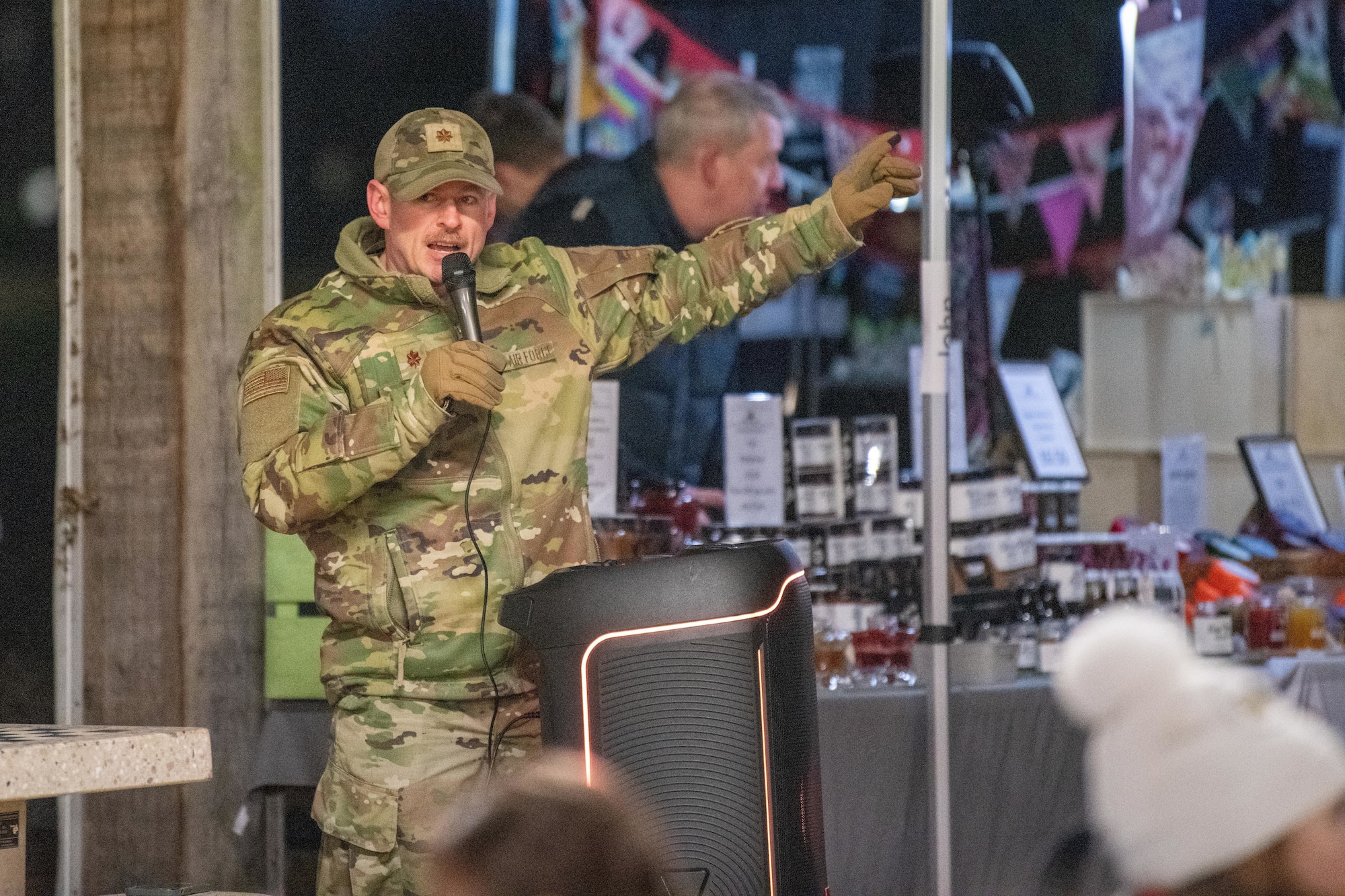 Commander makes an announcement during a holiday market