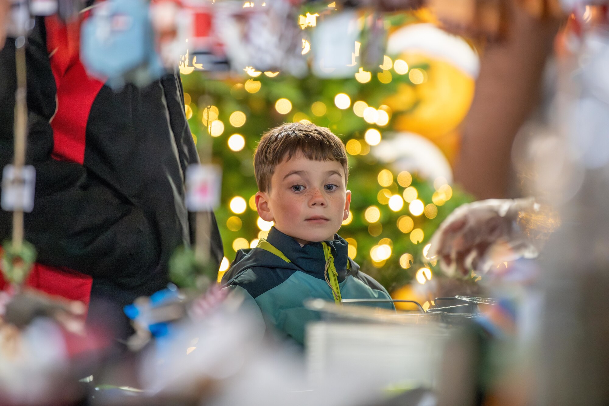A child browses items at a holiday market