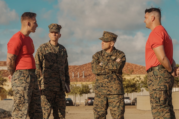 U.S Marine Corps Maj. Gen. James B. Wellons, center right, commanding general of 3rd Marine Aircraft Wing, and Col. Peter M. Rummler, center left, the commanding officer of Recruit Training Regiment, Marine Corps Recruit Depot San Diego converse with the commanding officer and series commander of Bravo Company, 1st Recruit Training Battalion, during a visit at MCRD San Diego and Western Recruiting Region, California, Nov. 18, 2024.  Wellons and his staff visited MCRD San Diego to observe training and learn how MCRD-SD and WRR operates. (U.S. Marine Corps photo by Lance Cpl. Janell B. Alvarez)