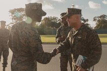 U.S Marine Corps Maj. Gen. James B. Wellons, right, commanding general of 3rd Marine Aircraft Wing, gives a coin to Sgt. Maj. Oranjel Leavy, left, the sergeant major of Marine Corps Recruit Depot San Diego and the Western Recruiting Region, during a visit at MCRD San Diego and Western Recruiting Region, California, Nov. 18, 2024. Wellons and his staff visited MCRD San Diego to observe training and learn how MCRD-SD and WRR operates. (U.S. Marine Corps photo by Lance Cpl. Janell B. Alvarez)
