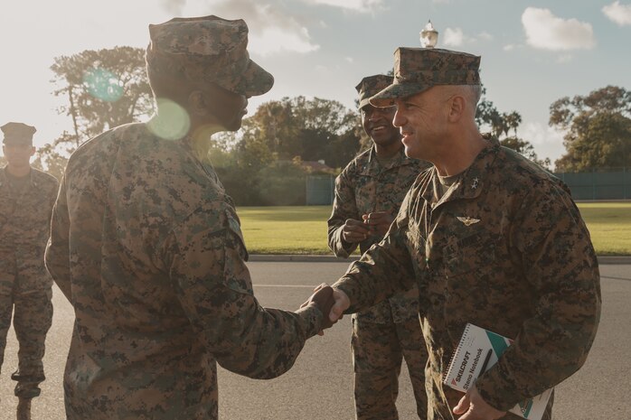 U.S Marine Corps Maj. Gen. James B. Wellons, right, commanding general of 3rd Marine Aircraft Wing, gives a coin to Sgt. Maj. Oranjel Leavy, left, the sergeant major of Marine Corps Recruit Depot San Diego and the Western Recruiting Region, during a visit at MCRD San Diego and Western Recruiting Region, California, Nov. 18, 2024. Wellons and his staff visited MCRD San Diego to observe training and learn how MCRD-SD and WRR operates. (U.S. Marine Corps photo by Lance Cpl. Janell B. Alvarez)