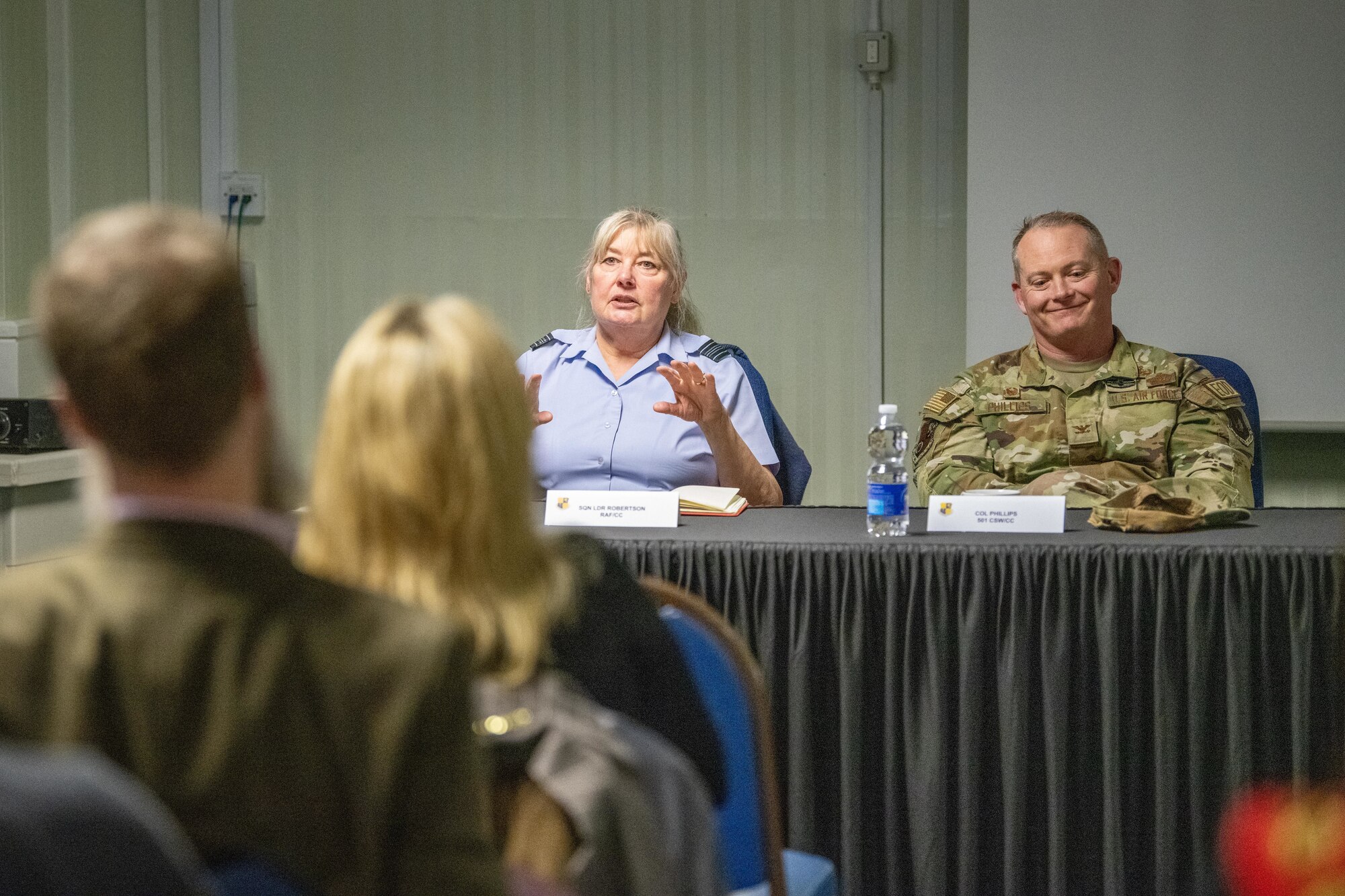 A commander speaks with civic leaders during an information evening