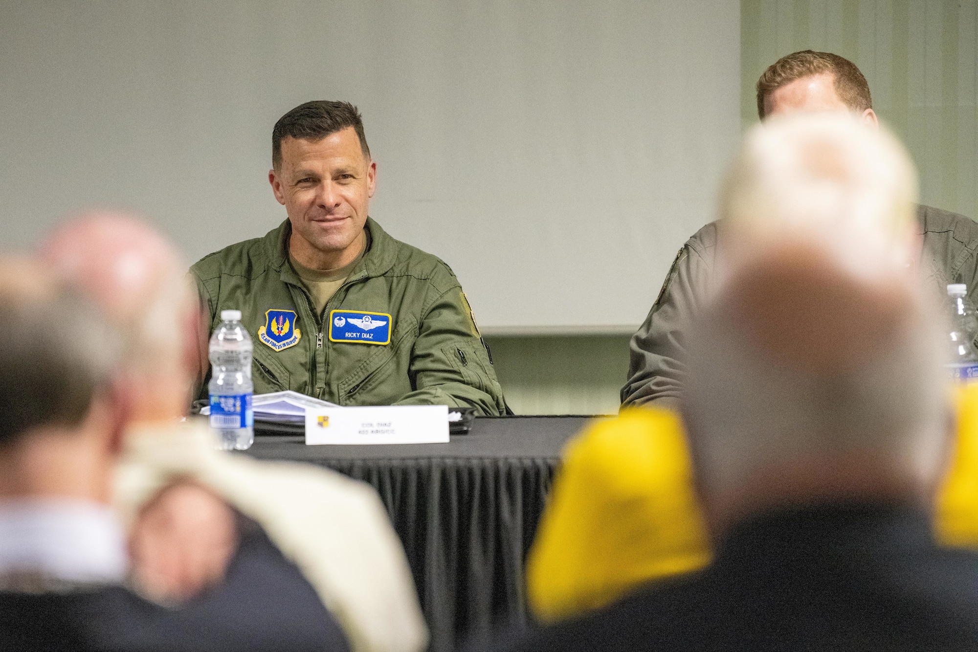 A commander listens to civic leaders during an information evening