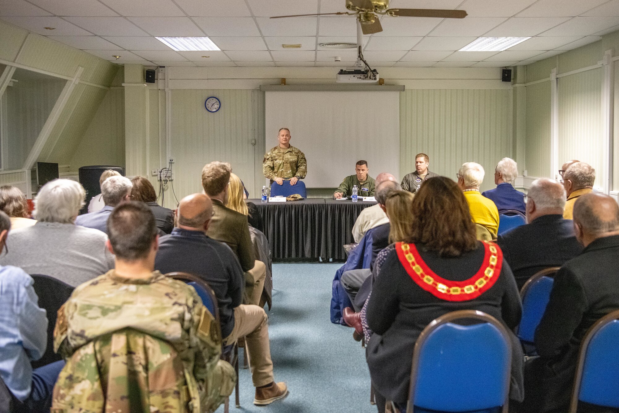 A commander speaks with civic leaders during an information evening