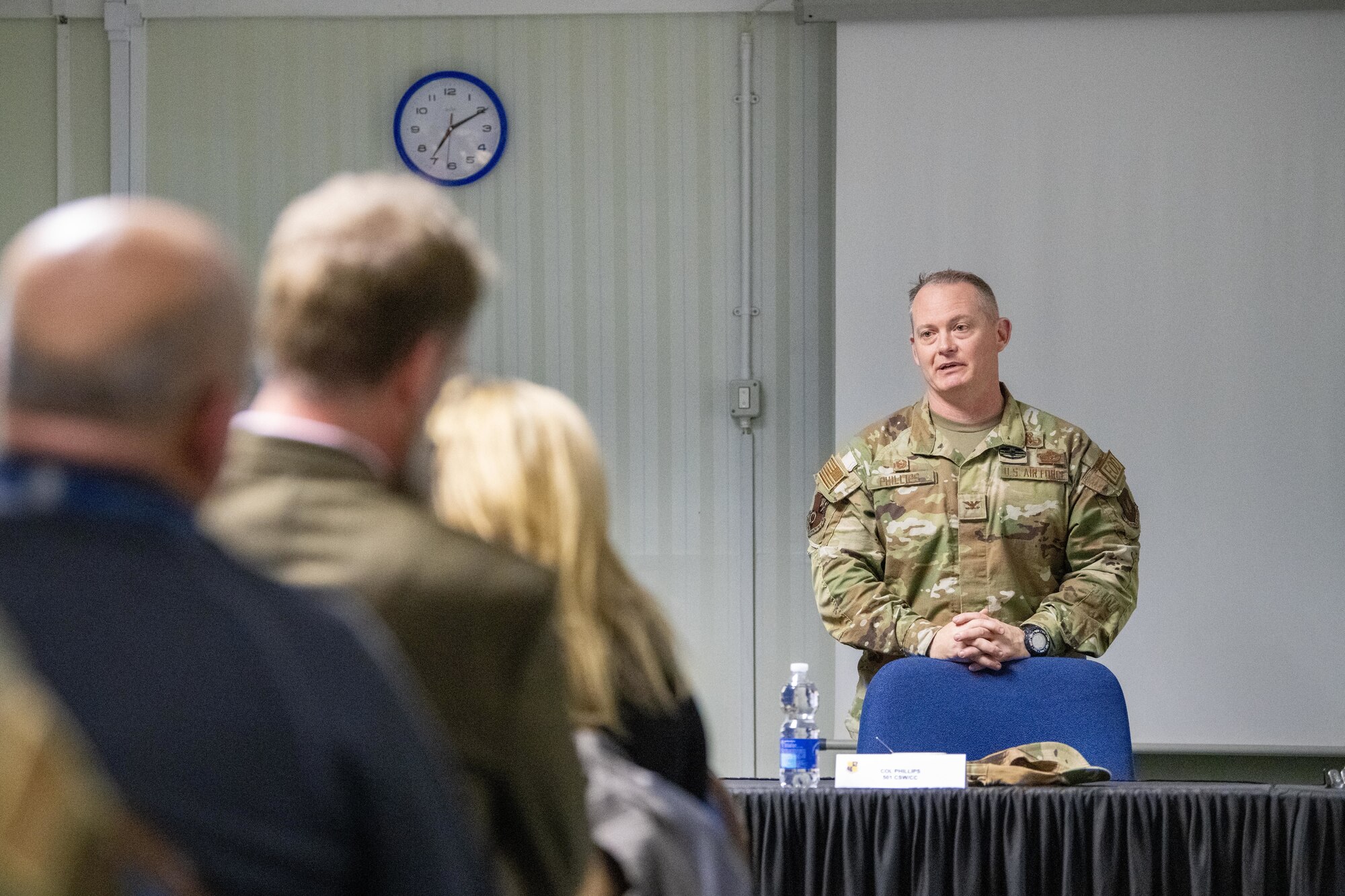 A commander speaks with civic leaders during an information evening