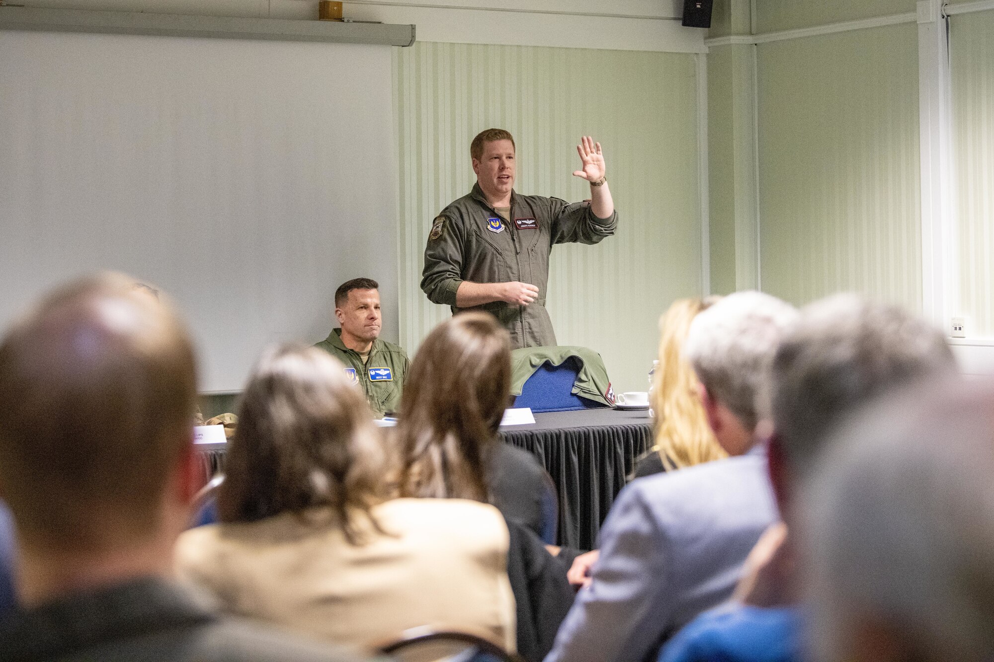 A commander speaks with civic leaders during an information evening