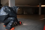 A member of the Massachusetts National Guard 1st Weapons of Mass Destruction Civil Support Team looks for signs of contamination during an evaluation training event at the Emerald Square Mall Nov. 7, 2024. The CST was tested over two days in North Attleboro.