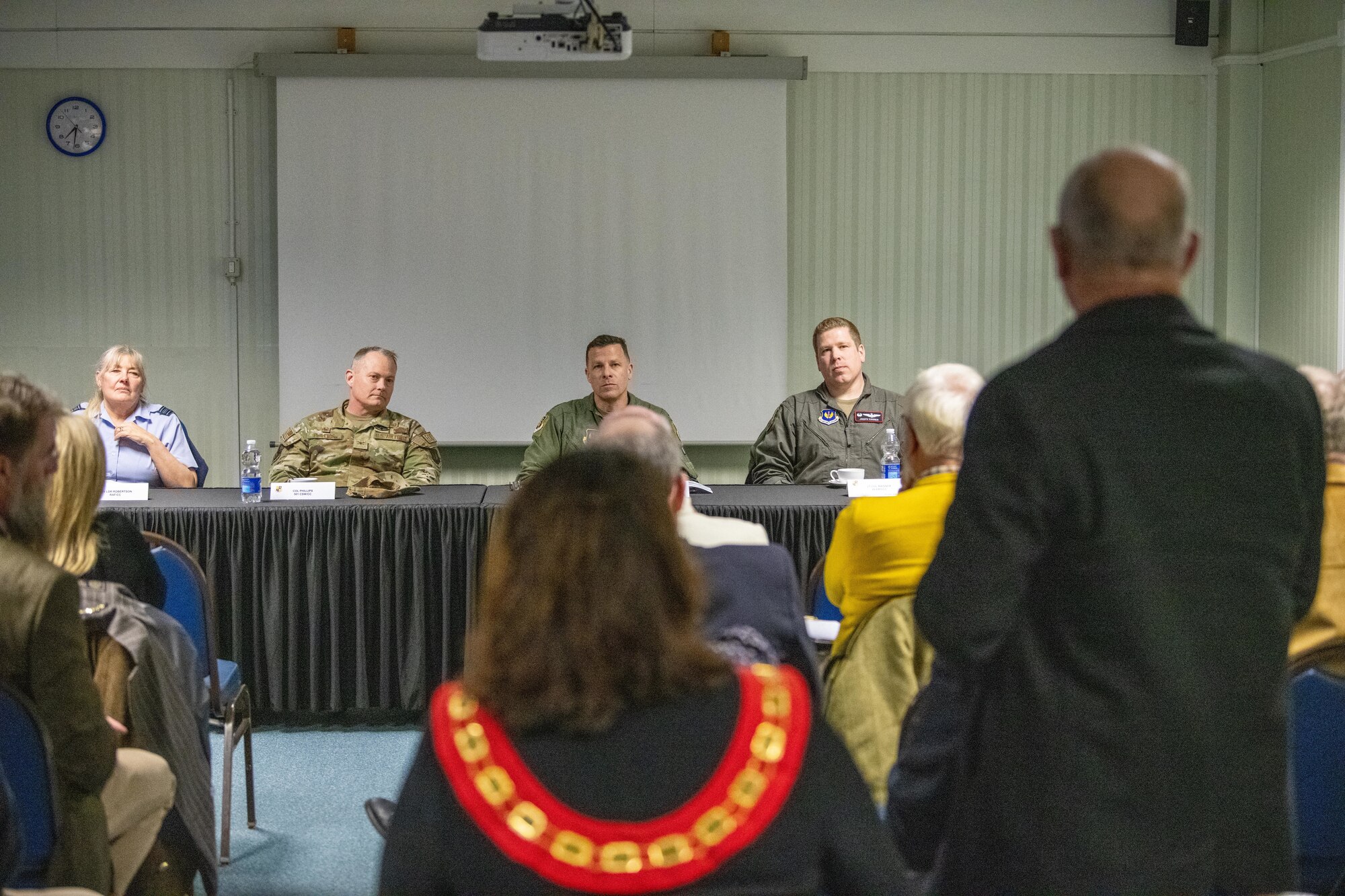 An attendee asks a question during an information evening