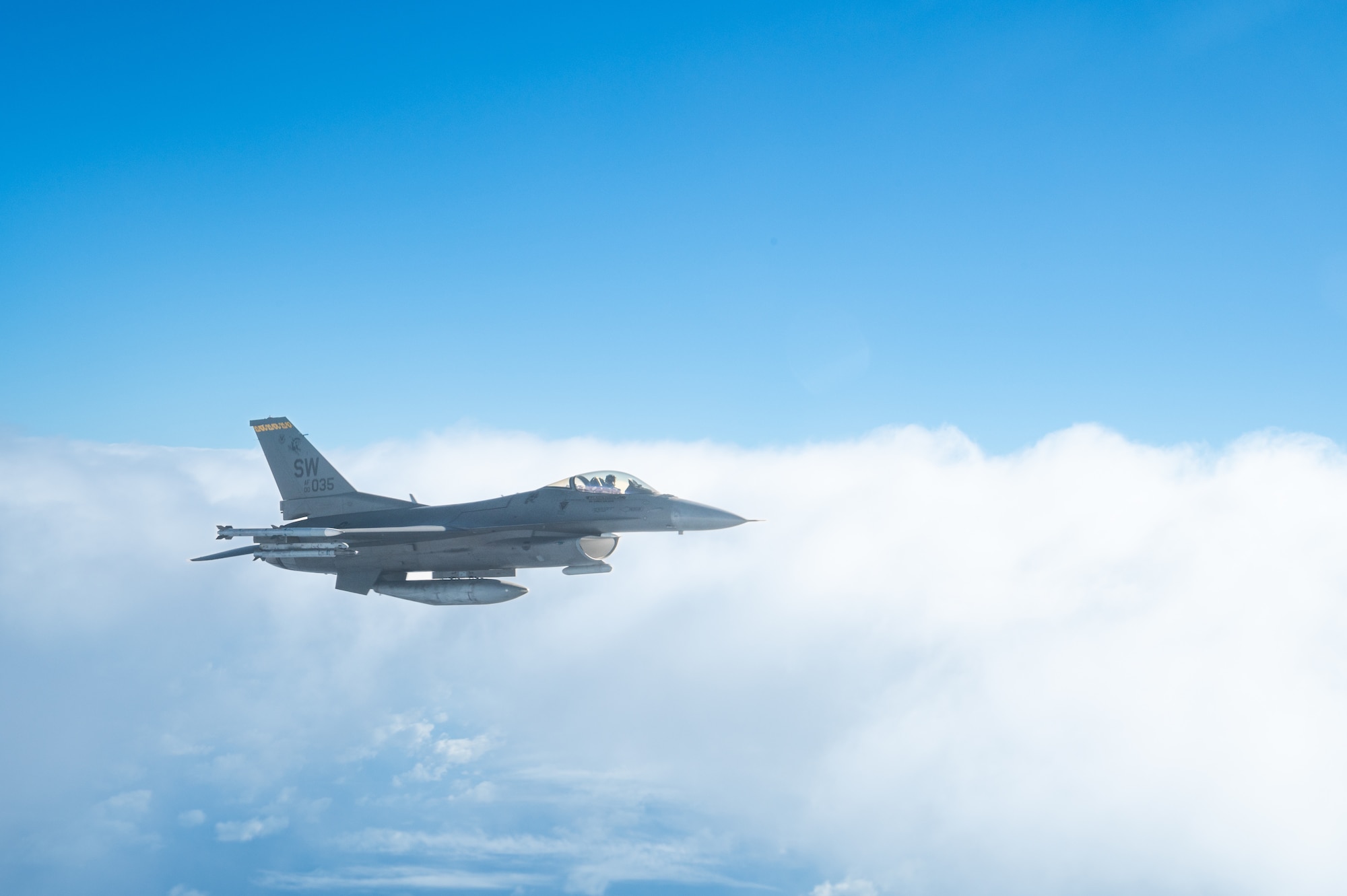 An aircraft flies over the ocean.