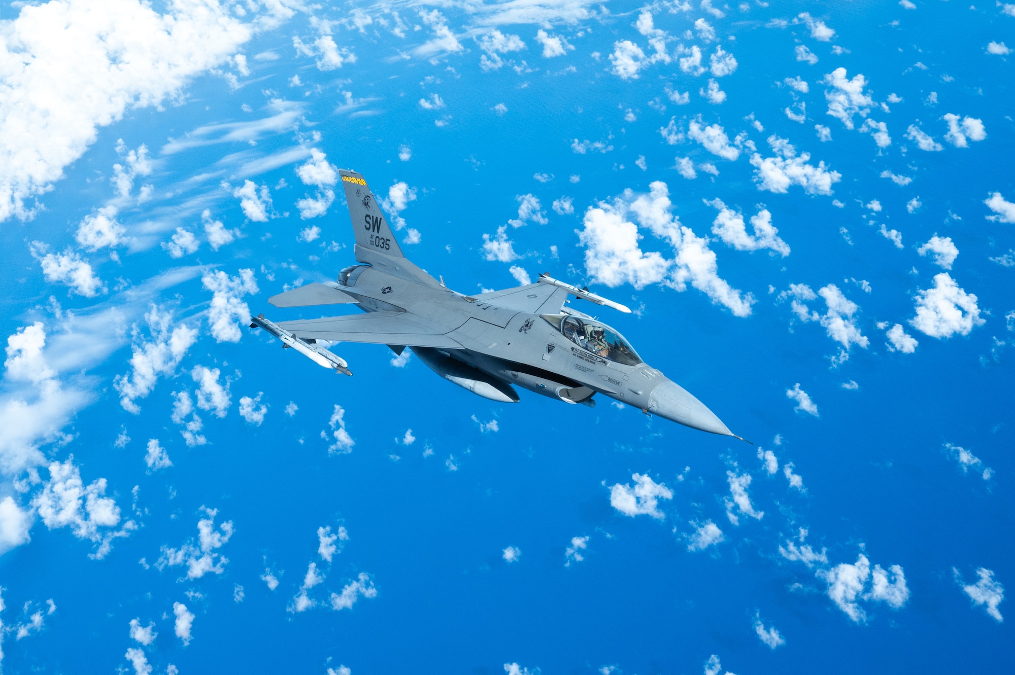 An aircraft flies over the ocean.