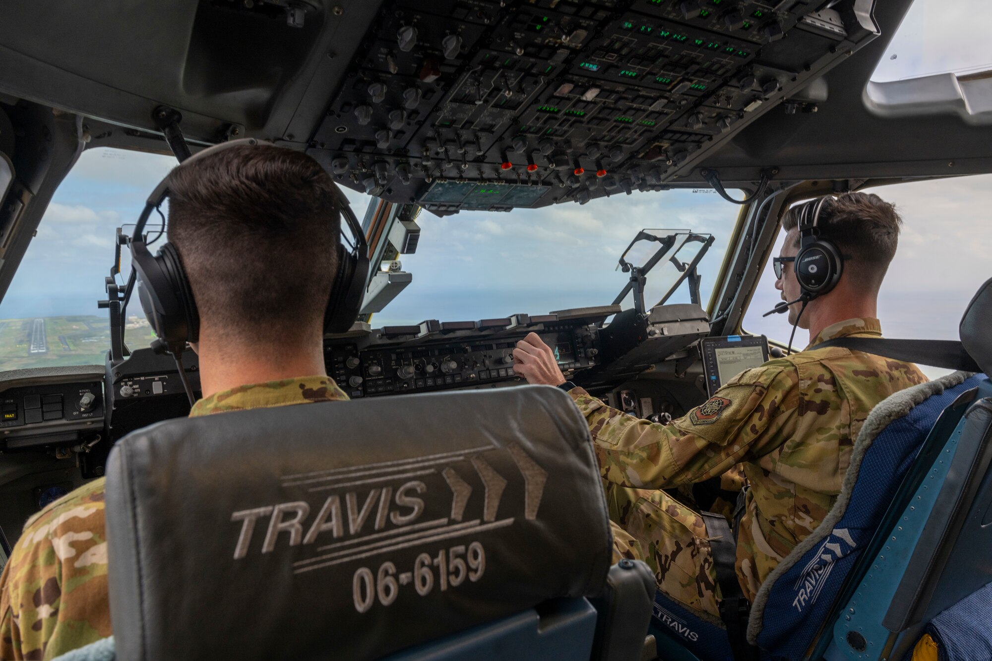 Two Air Force pilots prepare to land a C-17 Globemaster III in Japan