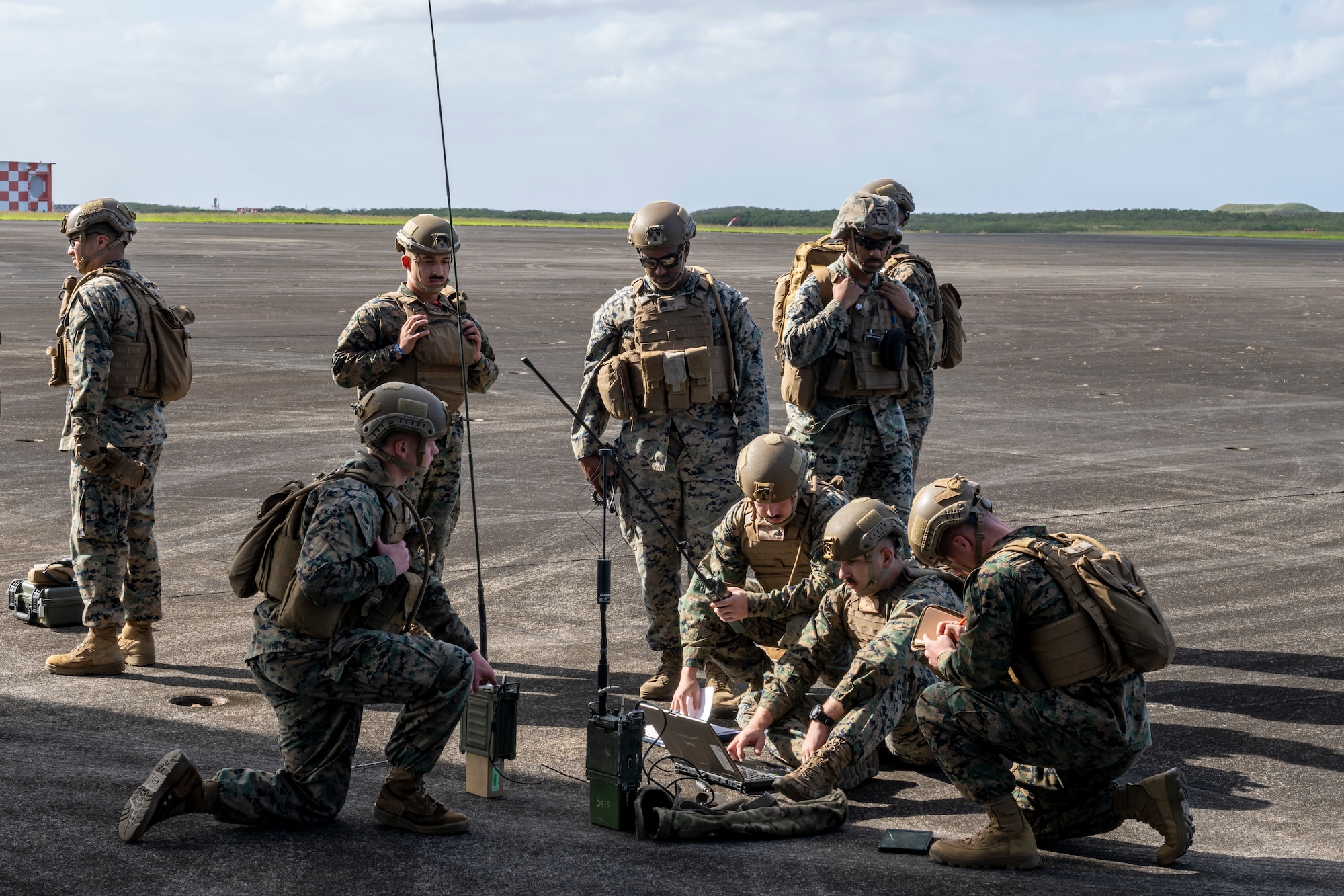 Marines hook up communication equipment on a flightline