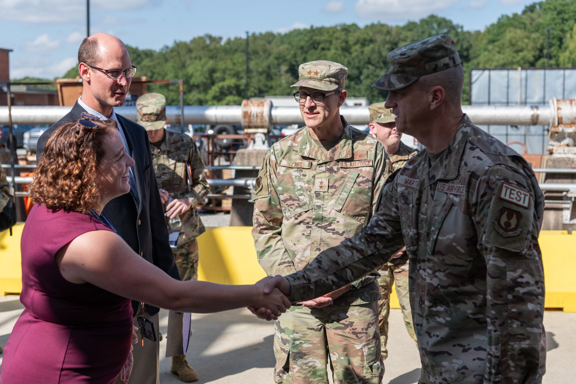 Chief Master Sgt. Jeffrey Martin, Air Force Test Center command chief, right, and Maj. Gen. Scott Cain, AFTC commander, second from right, are greeted by Rachel Garrard, section chief of the Air Force Research Laboratory High Speed Aerodynamics Branch at Arnold Air Force Base, Tenn., and Jamie Szmodis, chief of the AFRL High Speed Aerodynamics Branch, prior to the Oct. 2, 2024, ceremony at Arnold AFB to commemorate the 10th anniversary of the partnership between the AFRL and Arnold Engineering Development Complex. A unit of the AFTC, AEDC is headquartered at Arnold AFB. The partnership created the AFRL High Speed Aerodynamics Branch, which focuses on hypersonic research, at Arnold. (U.S. Air Force photo by Keith Thornburgh)