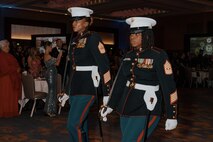 U.S. Marine Corps Sgt. Maj. Amina T. Saracay, sergeant major of 2nd Recruit Training Battalion, Recruit Training Regiment, left, and 1st Sgt. Latoya C. Moffett, unit senior enlisted leader with Support Battalion, RTR, right, participate as sword detail during a birthday ball ceremony in San Diego, California, Nov. 8, 2024. A celebration of the 249th Marine Corps birthday was held to reflect on the traditions, history and legacy of the Marine Corps. (U.S. Marine Corps photo by Lance Cpl. Janell B. Alvarez)