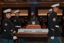 U.S. Marines with Marine Corps Recruit Depot San Diego march on the cake during a birthday ball ceremony in San Diego, California, Nov. 8, 2024. A celebration of the 249th Marine Corps birthday was held to reflect on the traditions, history and legacy of the Marine Corps. (U.S. Marine Corps photo by Lance Cpl. Janell B. Alvarez)