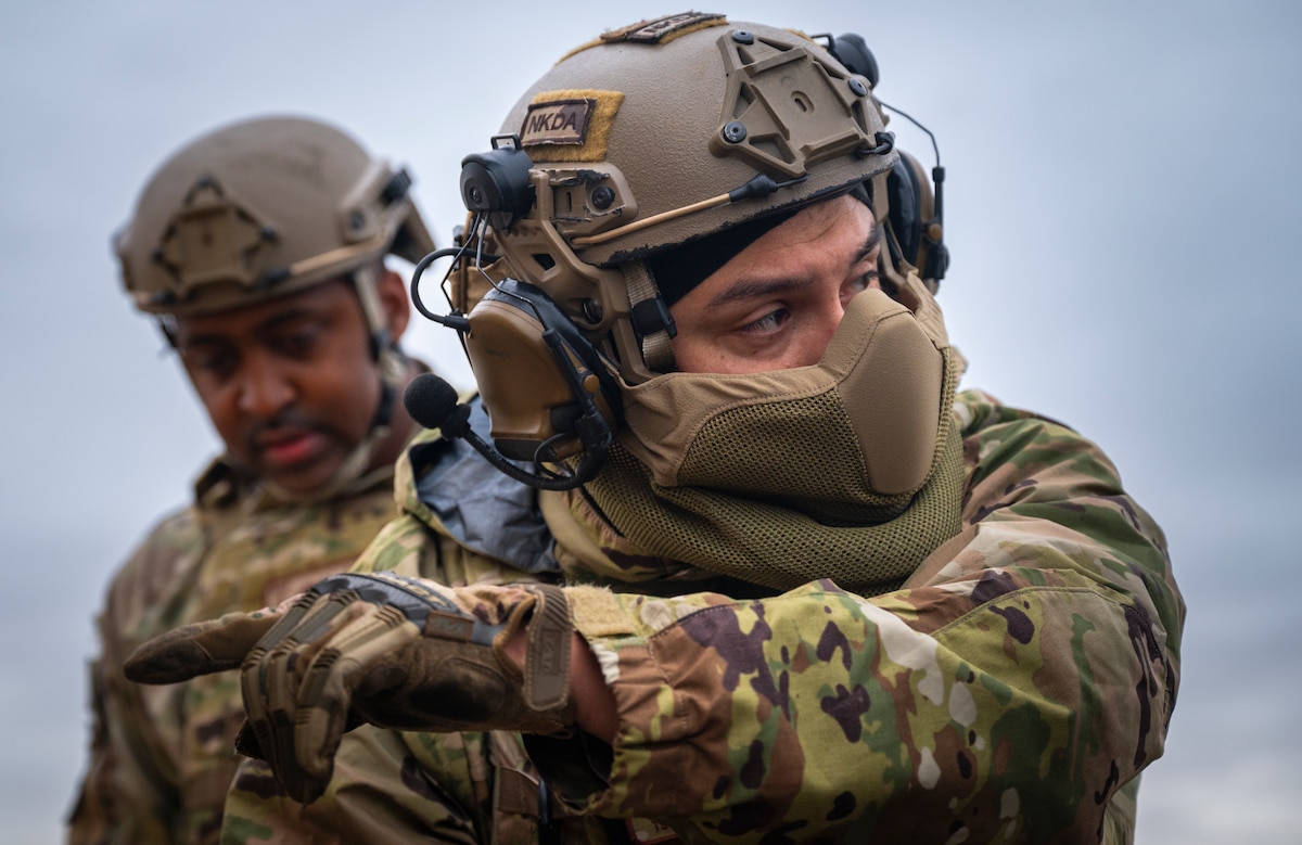 Tech. Sgt. Joel Stiffarm, 821st Contingency Response C-5 airlift mission specialist, guides other Airmen while setting up a tent during a part task trainer at the Global Readiness Deployment Center on Travis Air Force Base, California, Nov. 21, 2024.