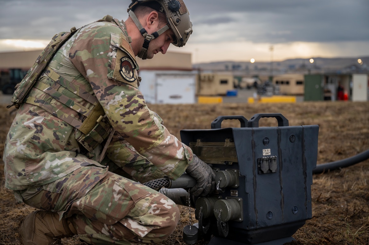 Tech. Sgt. Ty Craiglow, 821st Contingency Response Squadron unit type code management section chief, secures a power cable to a generator during a part task trainer at the Global Readiness Deployment Center on Travis Air Force Base, California, Nov. 21, 2024.