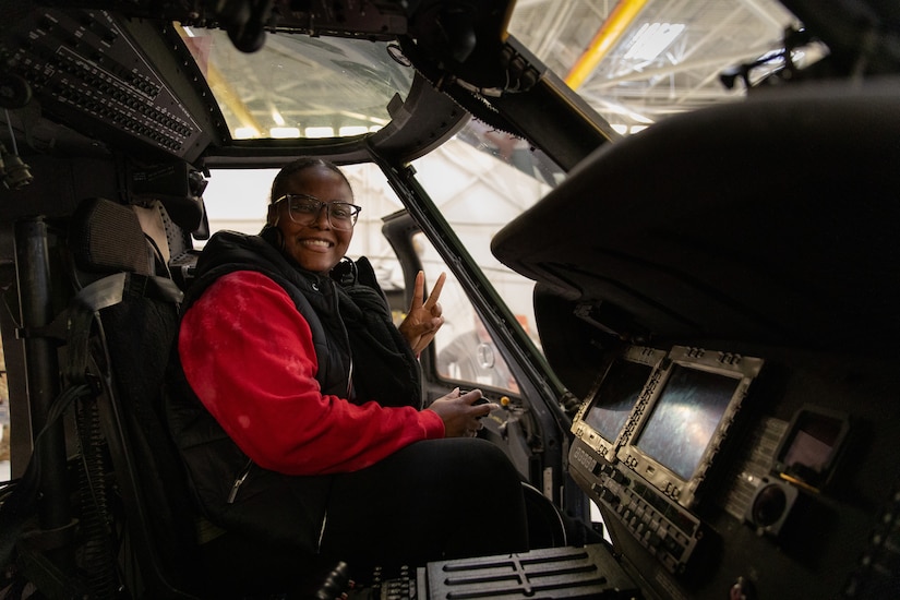 A member of Leadership Frankfort poses for a photo in a UH-60 Blackhawk on Boone National Guard Center in Frankfort, Kentucky on Nov. 21, 2024.  The Kentucky National Guard invited the group Leadership Frankfort to engage with local commerce leaders on the dual mission of the National Guard. (U.S. Army National Guard photos by Andy Dickson)