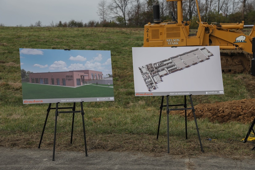 Building renderings from the construction company sit on display during the groundbreaking ceremony of the new maintenance facility at the Burlington Readiness Center in Northern Kentucky Nov. 18, 2024. The new facility will include wide maintenance bays, storage and administration space capable of sustaining modern military vehicles and equipment in Kentucky’s fastest growing area for population. (U.S. Army National Guard photo by Sgt. 1st Class Benjamin Crane)