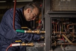 Man working on a heat pump.