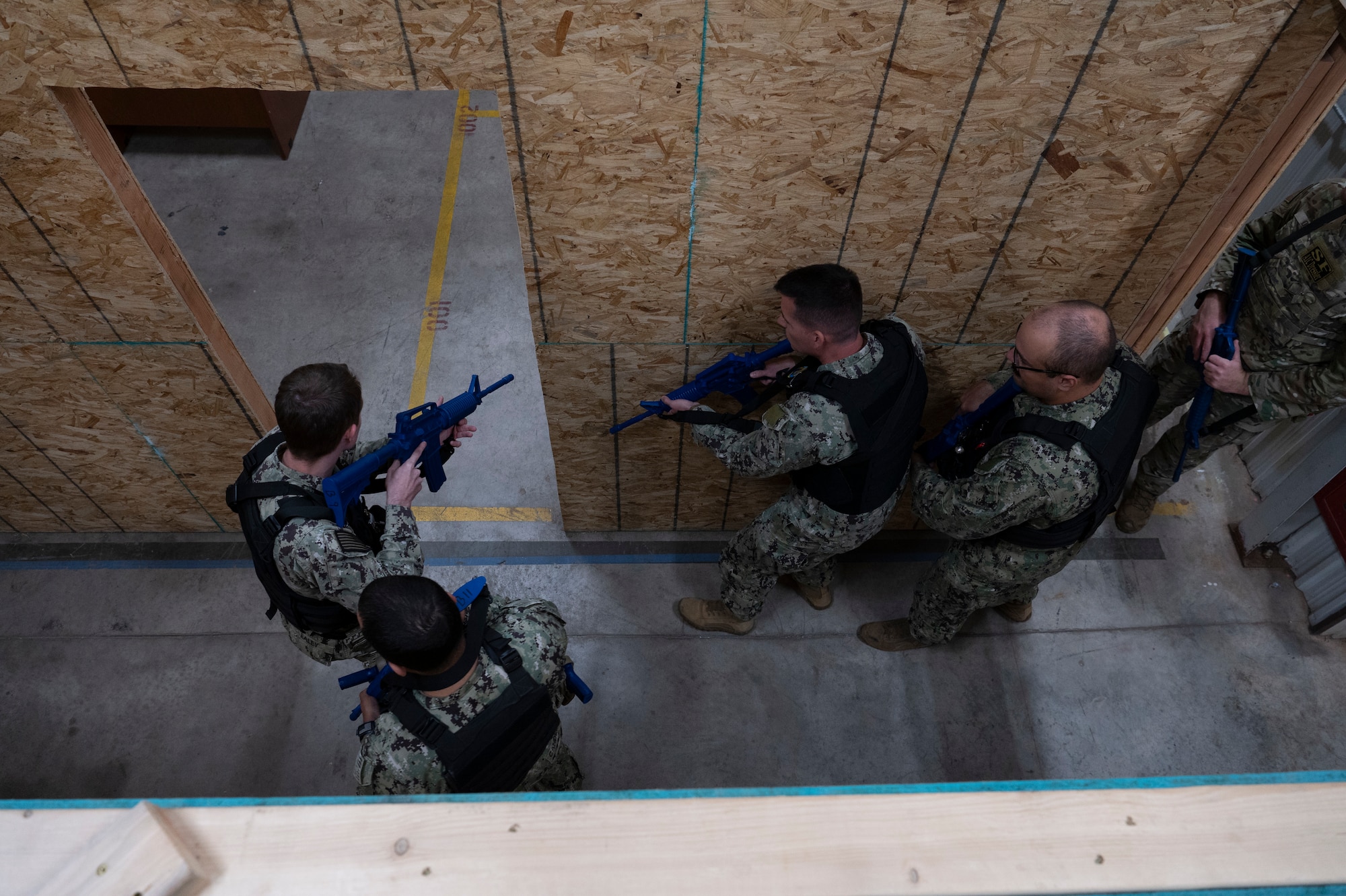 military men tactically enter a room