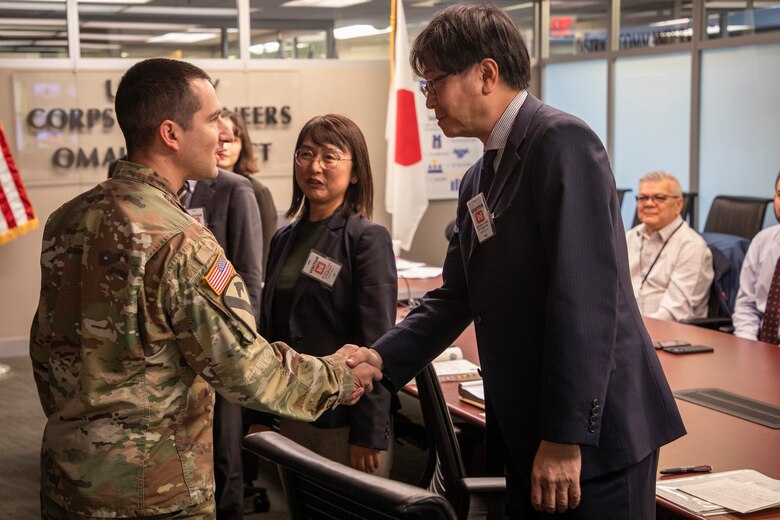 Lt. Col. Matthew Burgoon, deputy commander, U.S. Army Corps of Engineers, Omaha District, shakes hands with Mikio Maruyama, director, Facilities Construction and Procurement Division, Bureau of Defense Building Planning, Japan Ministry of Defense, during an engineer exchange Nov. 8, 2024, at the Edward Zorinksy Federal Building in Omaha, Nebraska.