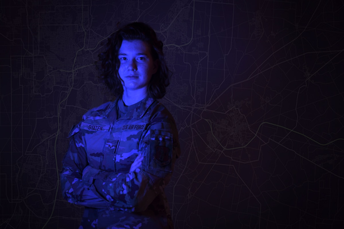 Image of Senior Airman Staten with blue lighting and graphic design to look like a cracked computer screen.