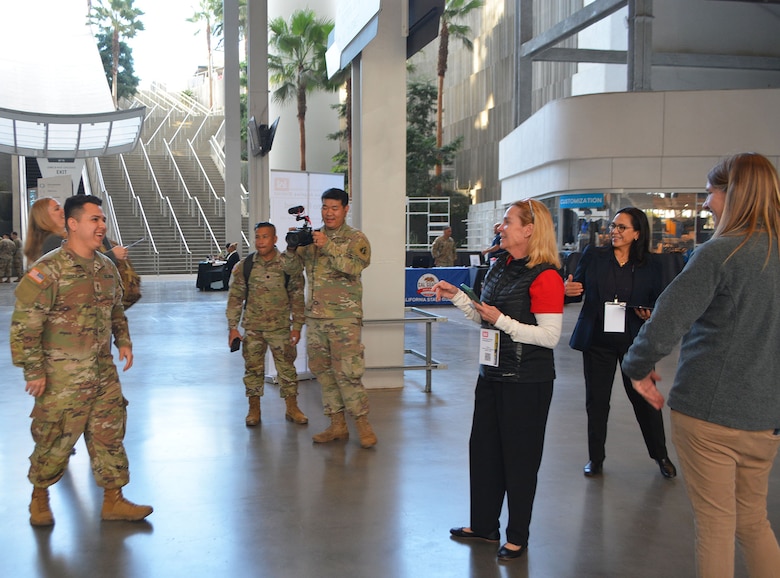 First lieutenant Jacob Zendejas, right, receives an on-the-spot tentative job offer from the U.S. Army Corps of Engineers, while celebrated by his recruitment battalion, during the Total Army Career Fair Nov. 2 at SoFi Stadium in Inglewood, California. Zendejas was one of 12 applicants, who received an on-the-spot tentative job offer to work for USACE.
