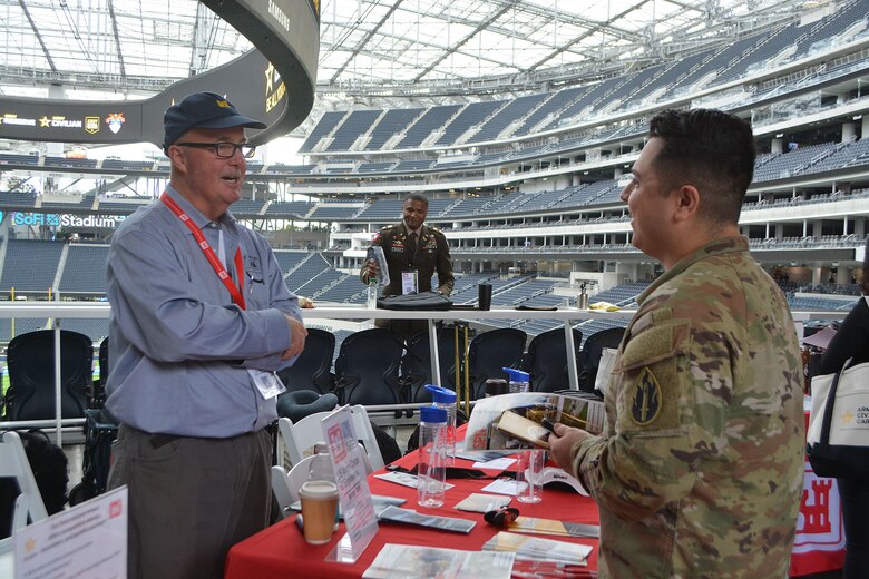 First lieutenant Jacob Zendejas speaks with a U.S. Army Corps of Engineers representative about careers with USACE during the Total Army Career Fair Nov. 2 at SoFi Stadium in Inglewood, California. Zendejas was one of 12 applicants, who received an on-the-spot tentative job offer to work for USACE.