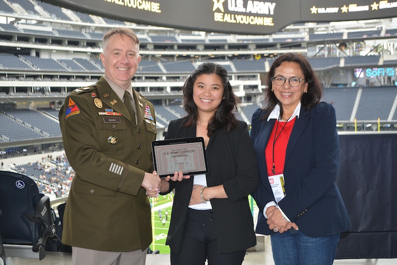 Col. Michael Baim, deputy commander of the U.S. Army Corps of Engineers South Pacific Division, left, and Erika Powell, Chief of the Civil Design Section, Engineering Division, USACE San Francisco District, right, present an on-the-spot job offer to Dionne Lu of Los Angeles, center, during the Total Army Career Fair Nov. 2 at SoFi Stadium in Inglewood, California.