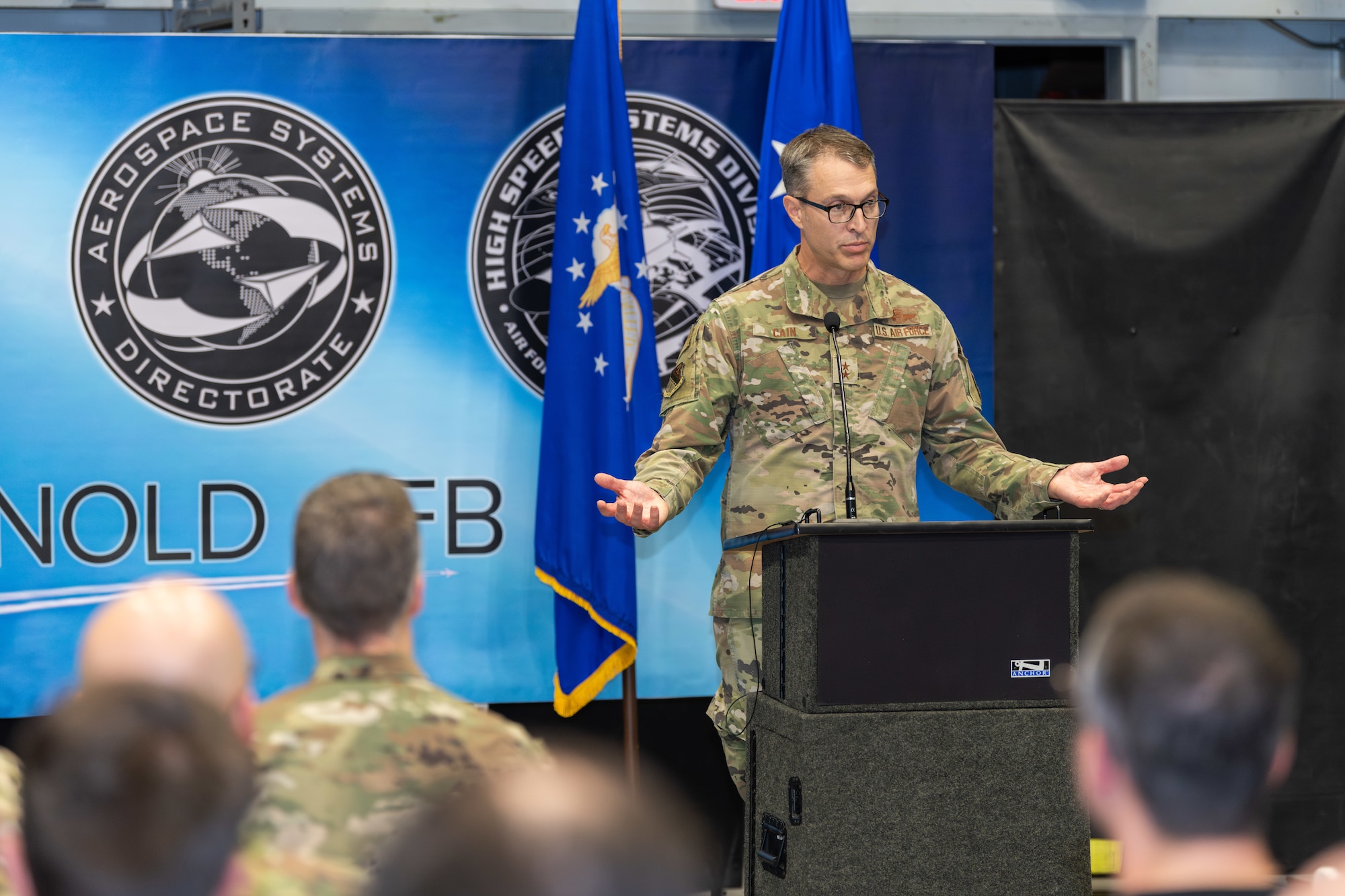 Maj. Gen. Scott Cain, Air Force Test Center commander, speaks during the Oct. 2, 2024, ceremony held in the von Kármán Gas Dynamics Facility at Arnold Air Force Base, Tenn., to commemorate the 10th anniversary of the partnership between the Air Force Research Laboratory and Arnold Engineering Development Complex. A unit of the AFTC, AEDC is headquartered at Arnold AFB. The partnership created the AFRL High Speed Aerodynamics Branch, which focuses on hypersonic research, at Arnold. (U.S. Air Force photo by Keith Thornburgh)
