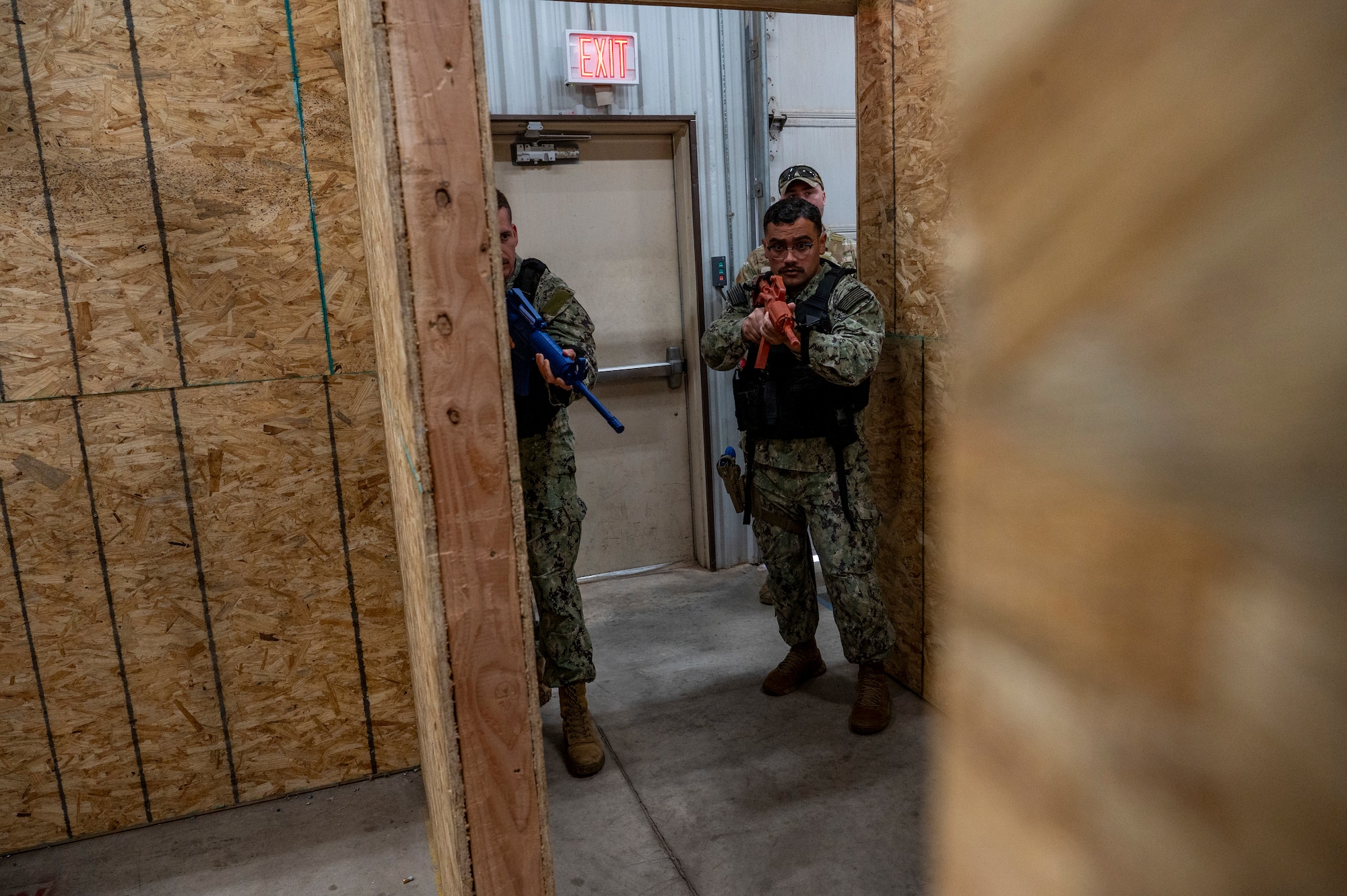 military men prepare to tactically enter a room