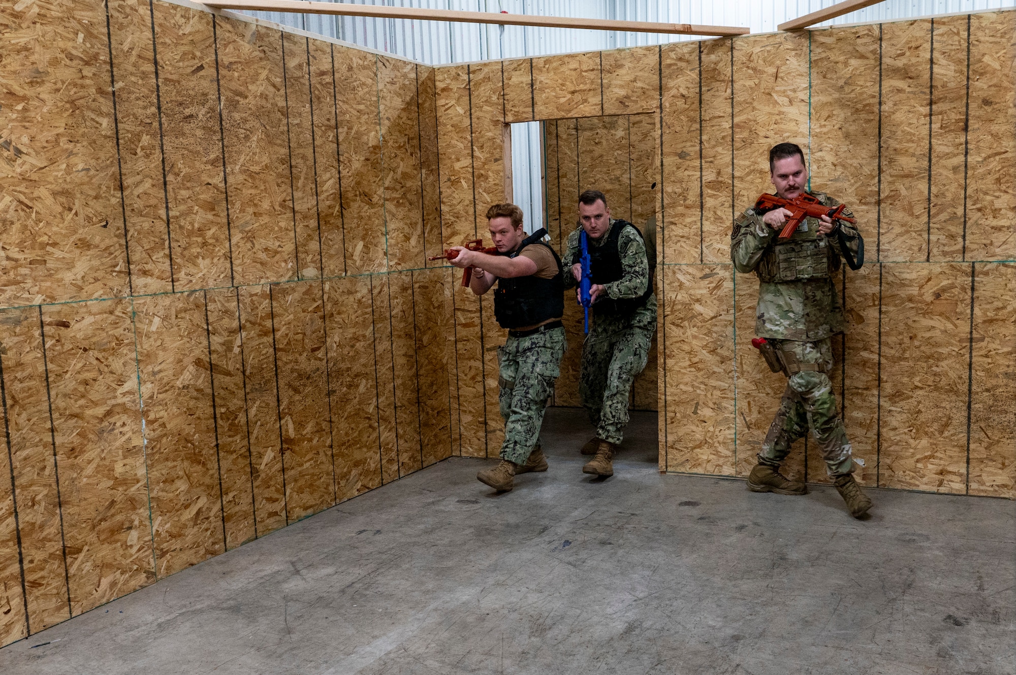 military men tactically enter a room