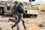 Soldiers with U.S. Army's 1st Special Forces Group (Airborne) and India's Special Operations Forces rush to cover at the Orchard Combat Training Center's Combined Arms Collective Training Facility near Boise, Idaho. The two units were joined by the Idaho Air National Guard's 124th Air Support Squadron to conduct Exercise Vajra Prahar Nov. 2-22.