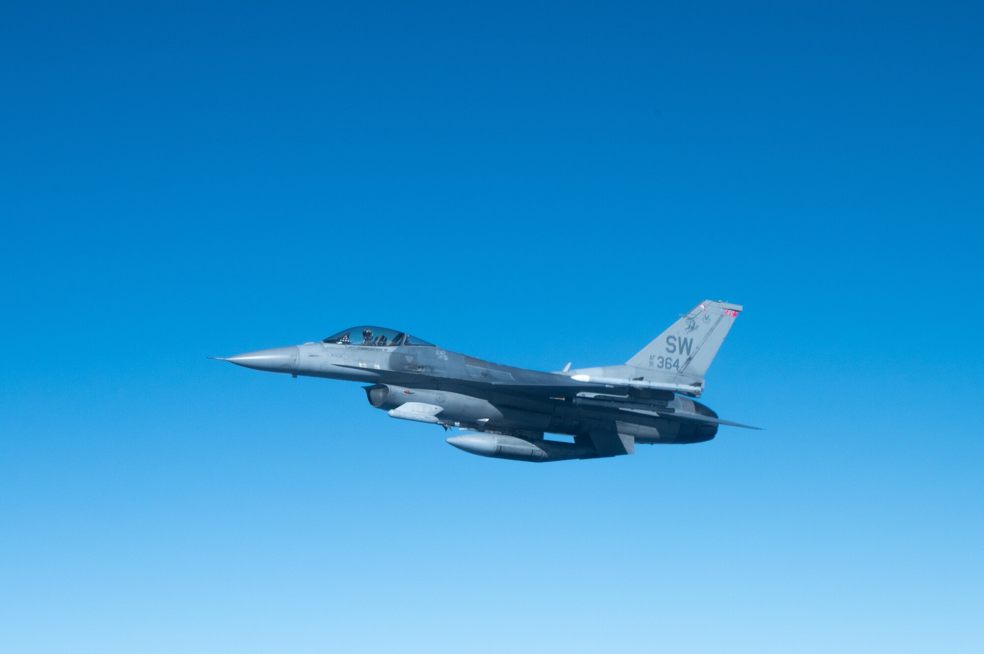 An aircraft flies over the ocean.